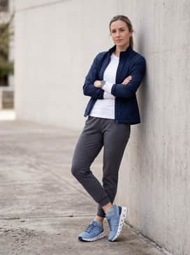 Cloudswift 3 – Tapered charcoal grey joggers, a fitted white long-sleeve moisture-wicking top, and a lightweight navy windbreaker for an active commute.