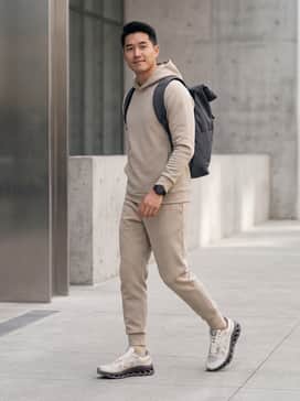 A monochromatic sand-colored tech-fleece jogger set with a matching slim-fit hoodie for a cohesive, futuristic streetwear aesthetic.