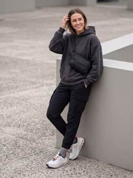Cloudultra 2 – Tapered black water-resistant cargo joggers combined with an oversized charcoal graphic hoodie and a sleek technical crossbody bag for a modern urban-adventure aesthetic.