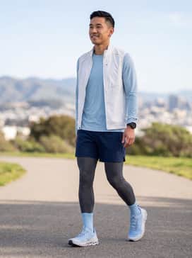 Cloudultra 2 – A performance-focused kit featuring navy blue compression tights, a light blue moisture-wicking long-sleeve top, and a white technical running vest.