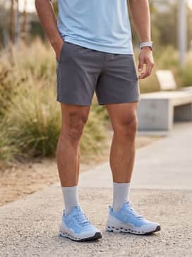 Cloudultra 2 – High-waisted charcoal grey athletic shorts paired with a breathable white racerback tank top and a matching sky blue sports headband.
