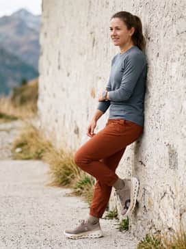 Technical ripstop hiking trousers in a burnt orange or rust hue to highlight the shoe's accents, styled with a slate grey merino wool base layer.