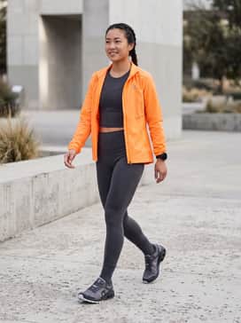 Cloudventure Peak 3 – Technical high-waisted compression leggings in charcoal, paired with a matching moisture-wicking cropped tank and a lightweight, windproof running shell in a vibrant neon for visibility.