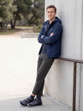 Cloudventure Peak 3 – A gorpcore-inspired look featuring tapered technical cargo pants in olive drab, a moisture-wicking base layer, and a hooded Gore-Tex jacket in navy blue for a rugged outdoor aesthetic.