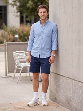 Cloudzone Moon – Navy blue chino shorts styled with a light blue linen button-down shirt and no-show socks for a polished yet comfortable summer outfit.