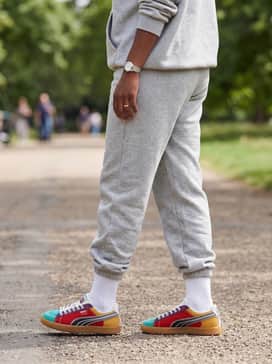 A monochromatic heather grey oversized sweatsuit set to provide a neutral backdrop that makes these sneakers the undeniable focal point.