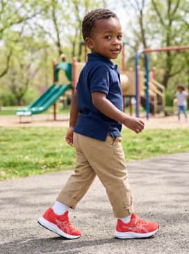 Khaki cargo shorts and a simple navy polo shirt for a semi-casual look that remains functional for high-energy play.
