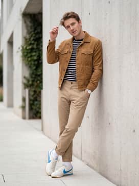 Cortez Leather – Straight-leg khaki chinos worn with a tucked-in striped Breton top and a tan corduroy trucker jacket for a smart-casual vintage ensemble.