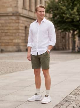 Court Classic Lux Suede – Olive green chino shorts and a white linen button-down shirt with rolled sleeves for a polished yet breathable summer ensemble.