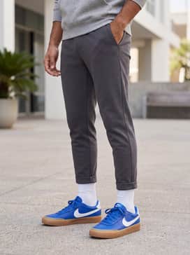 Court Shot – Tapered charcoal grey joggers paired with a heather grey hoodie and a matching blue baseball cap to highlight the shoe color.
