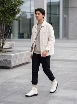 Court Vision Mid – Tapered black joggers paired with a crisp white oversized hoodie and a quilted olive bomber jacket to emphasize the shoe's high-top silhouette.