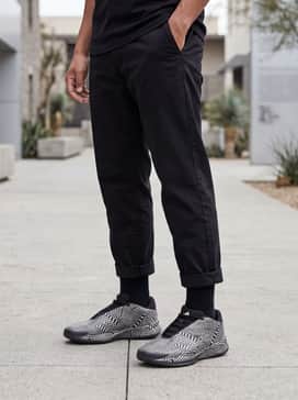 Crazy Energy Basketball Shoes – distressed black slim-fit jeans paired with an oversized white graphic t-shirt and a lightweight black bomber jacket for an urban streetwear aesthetic