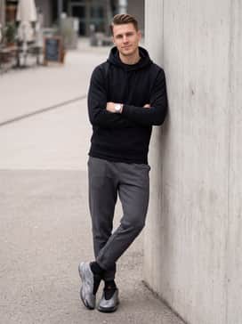 tapered charcoal grey joggers with a sleek black tech-fleece hoodie to lean into a modern athleisure vibe that lets the shoe's pattern stand out
