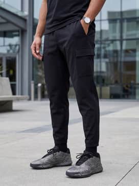Crazy Energy Basketball Shoes – Tapered black tech joggers with multiple utility pockets, a charcoal grey oversized graphic t-shirt, and a minimalist black bomber jacket.