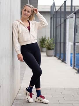 Crazyquick Lightstrike Padel Shoes – High-waisted black leggings paired with a burgundy sports bra and a cropped cream zip-up hoodie to highlight the shoe's color accents.