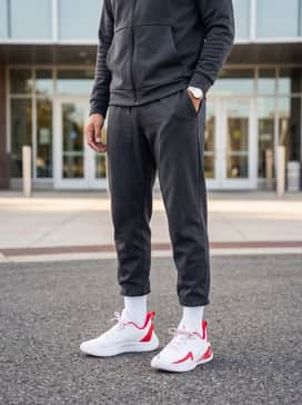 Curry 12 Team – Off-Court Casual: Pair with charcoal grey tapered joggers, a matching grey tech-fleece zip-up hoodie, and a red baseball cap to highlight the shoe's accents.
