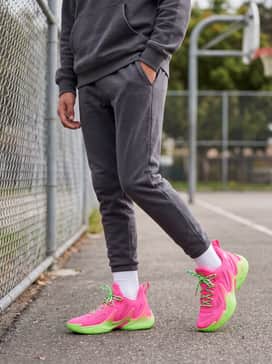 Casual school combo: Match with tapered charcoal grey joggers and a lime green graphic hoodie to emphasize the vibrant sole and laces.
