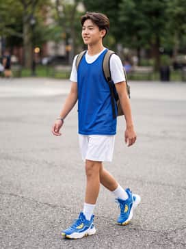 A full team uniform featuring a blue and gold mesh jersey with white breathable athletic shorts and high-performance crew socks.