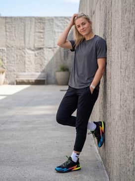 D Fox 2 Gamer – Stacked dark wash denim jeans with a slightly oversized graphic tee that incorporates one of the shoe's gradient colors, such as orange or electric blue.