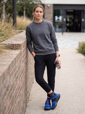 Tapered light-wash denim jeans with a white oversized graphic t-shirt for a casual weekend look that highlights the shoe's athletic silhouette.