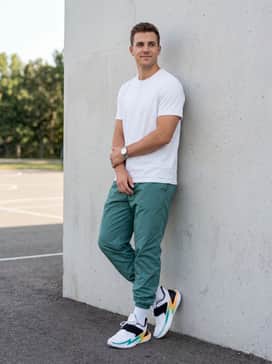 Teal or neon green nylon windbreaker pants and a simple white fitted t-shirt to lean into the shoe's vibrant 90s-inspired color palette for a bold streetwear statement.