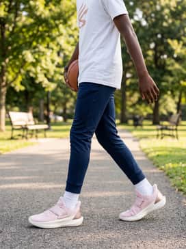 For a pre-game look, pair these sneakers with navy blue track pants and a white graphic t-shirt that features metallic or rose-colored lettering to tie the colors together.