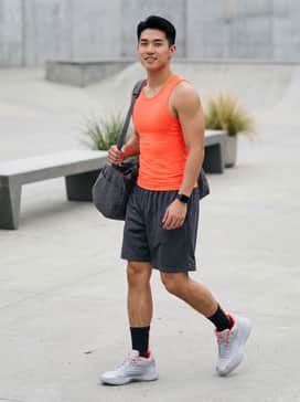 A pair of charcoal mesh basketball shorts paired with a compression tank top in a matching neon orange to highlight the shoe's accent colors.