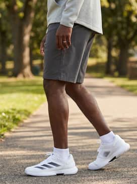 Style with olive green chino shorts and a light grey tech-fleece hoodie for a comfortable and contemporary athletic aesthetic.