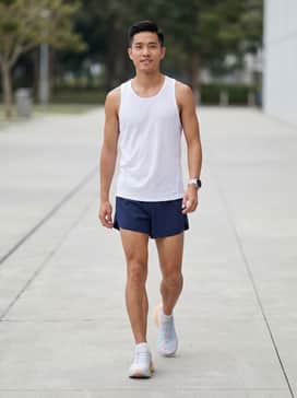 Deviate Nitro Elite 4 Run Club Mens Road Running Shoes – A race-day kit featuring navy blue micro-split running shorts, a white ultra-breathable mesh singlet, and a sleek GPS sports watch.