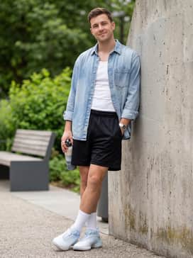 Don Issue 7 Shoes Na – Black mesh basketball shorts, white crew socks pulled mid-calf, and a vintage-wash blue denim shirt worn open over a white tank top.
