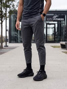 A gym-ready ensemble consisting of tapered tech-fleece joggers in charcoal, a fitted performance tee with reflective details, and a moisture-wicking headband.