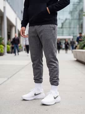 Classic gym aesthetic: Match with tapered heather-grey joggers, a fitted black performance tee, and a matching zip-up tech-fleece hoodie for cooler morning workouts.