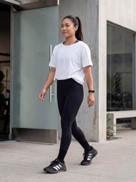 Pair with black high-waisted compression leggings, a charcoal sports bra, and an oversized white pump cover for a classic lifting aesthetic.