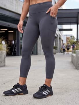 Style with silver-toned bike shorts and a matching tight-fit crop top for a sleek, futuristic look that highlights the shoe's metallic accents.