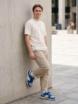 Beige carpenter pants worn with a cream-colored heavyweight cotton tee and a silver chain necklace for a clean, workwear-inspired look.