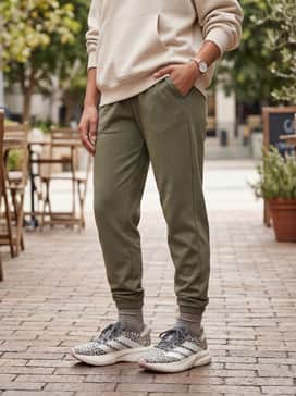 Olive green joggers and a neutral-toned oversized hoodie for a stylish post-workout brunch or errand run.