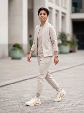 Dynasty – A monochromatic oatmeal-colored tech fleece jogger set paired with a matching structured gilet for a cohesive, athletic-luxe aesthetic.