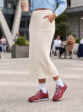 Easy Rider Cherry Blues Womens Sneakers – A cream-colored knitted midi skirt and a baby blue cropped sweater that highlights the shoe's secondary accent color.