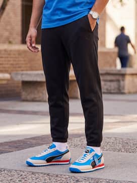 Easy Rider Club Las Vegas – Tapered black joggers paired with a heather grey crewneck sweatshirt and a charcoal puffer vest to let the electric blue of the shoes pop as the statement piece.