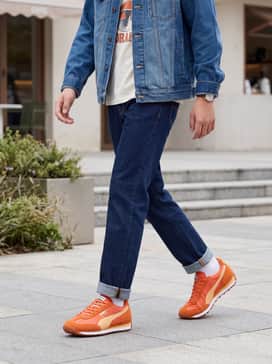 Dark wash straight-leg jeans paired with a vintage-inspired graphic tee and a denim jacket for a classic retro look.
