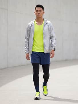 Equipment Adios Pro Shoes – A professional marathon kit featuring navy blue compression leggings, a breathable neon yellow mesh tank top, and a lightweight metallic silver windbreaker for early morning sessions.