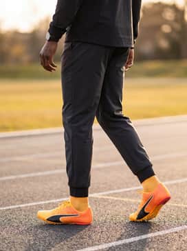 Evospeed Future 6 Track  Field Sprinting Spikes – A full aerodynamic track suit in charcoal grey or deep black to make the vibrant orange spikes pop during pre-race warm-ups.
