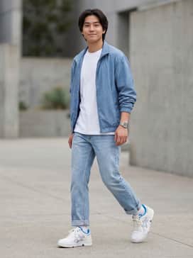 Light-wash straight-leg denim jeans with a slight cuff, paired with a crisp white heavyweight t-shirt and a blue windbreaker to echo the shoe's accents.