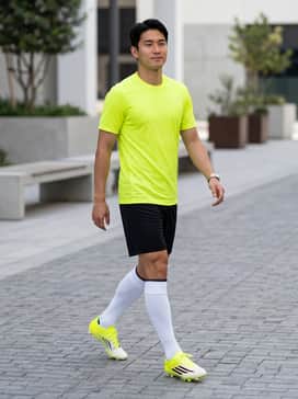A complete team match kit including a vibrant yellow performance jersey, black athletic shorts, and high-performance soccer socks.