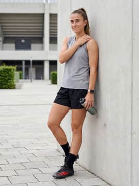 F50 Elite Firm Ground Football Boots – A summer practice outfit pairing a lightweight grey sleeveless tech-tee with black ventilated mesh shorts and low-cut athletic grip socks.
