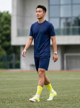 F50 Elite Firm Ground Soccer Cleats – A complete team match kit consisting of a navy blue jersey and shorts paired with neon yellow-accented performance socks.