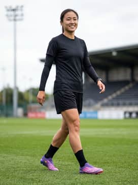 F50 Elite Ly Laceless Firm Ground Cleats – A streamlined black performance kit featuring a sleek compression base layer and minimalist shorts to allow the iridescent shoes to stand out as the focal point.