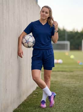 Full team uniform in deep navy or purple with white mid-calf athletic socks to emphasize the vibrant color transition and holographic finish of the cleats.