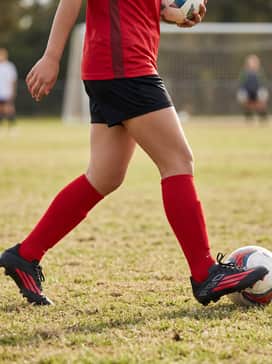 F50 League Firm Ground  Multi Ground Soccer Boots Kids – A full team soccer kit featuring a moisture-wicking red jersey, black performance shorts, and high-compression red soccer socks.