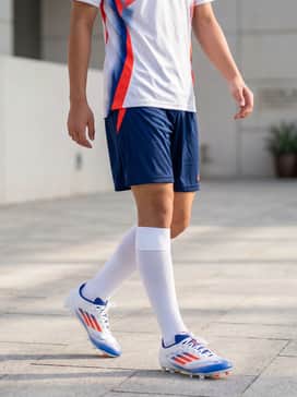 F50 League Multiground Soccer Cleats – A matching team soccer jersey with moisture-wicking shorts and knee-high performance socks for a complete match-day look.